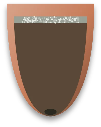 A pot cut in half, with a thin band of pale grit lying on top of the compost.