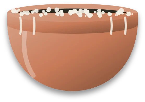 A terracotta pot with a chalky white crust along the rim and streaks of it running down the outside.